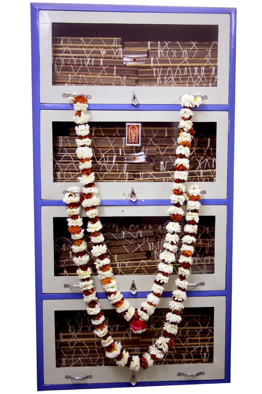 Close-up of bundled Siva Nadi palm-leaf manuscripts with inscribed verses